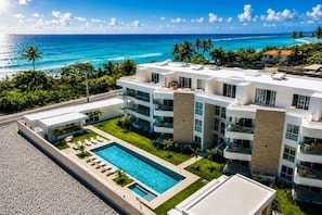 A modern hotel with a rooftop pool, ocean views, and a well-maintained lawn. - Penthouse in Cabarete. Pool, Gym & Beach (Cabarete)