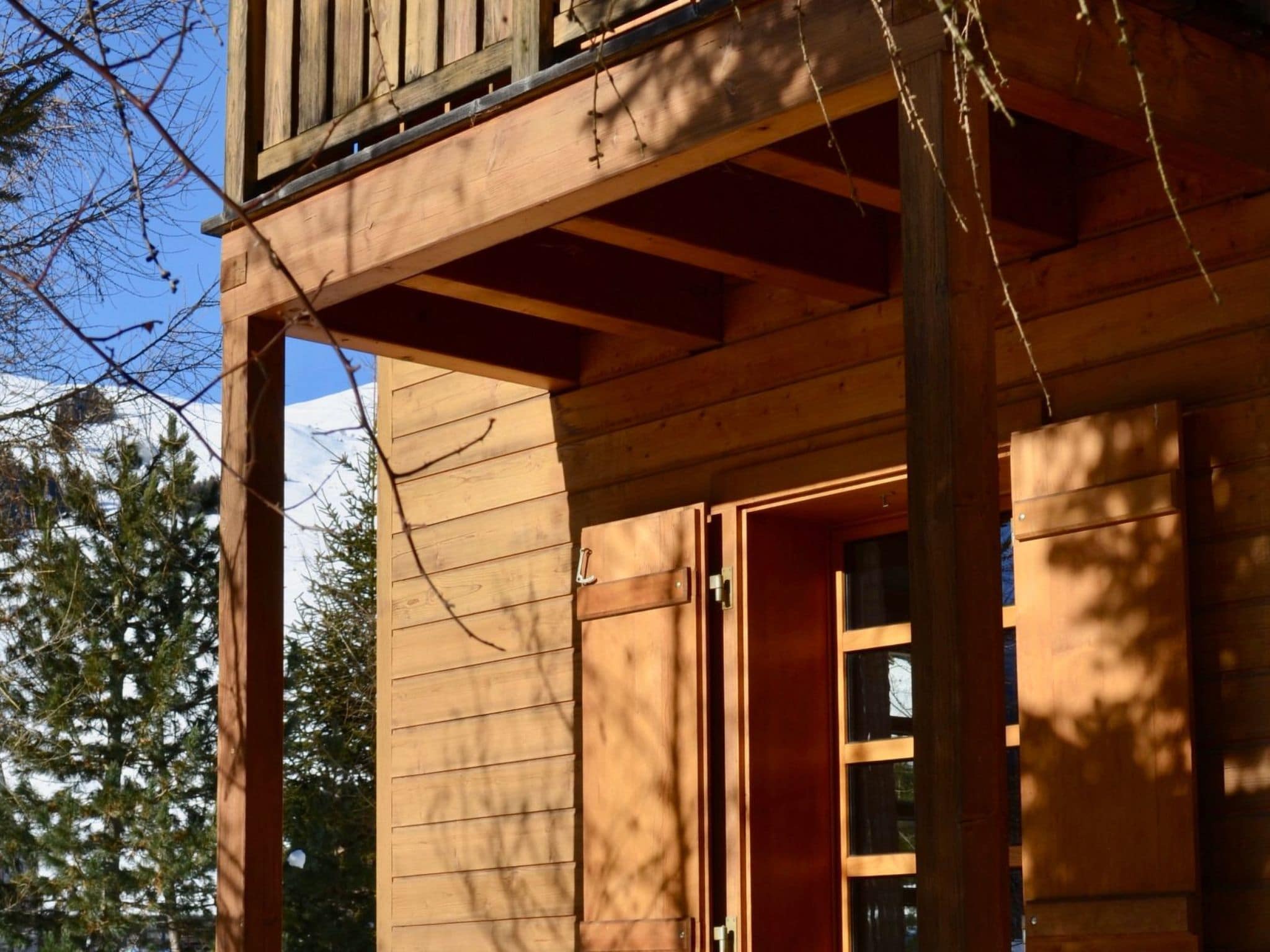 A wooden building with a balcony and a door.