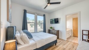 A bedroom with a bed, a ceiling fan, a TV, and a window. - *New* Austin Skyline Vista 🦚 | Rooftop Views, South First Vibes 🌵🎸 (Austin)