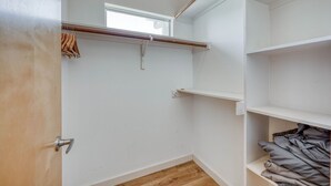 A walk-in closet with a wooden floor, white walls, and a window. - *New* Austin Skyline Vista 🦚 | Rooftop Views, South First Vibes 🌵🎸 (Austin)