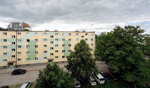 A multi-story residential building with a parking area in front. - Baltic Seaside Homely Apartment (Gdańsk)