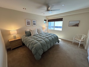 A bedroom with a bed, a nightstand, a chair, a ceiling fan, and a window with blinds. - Steps to Mission Bay! 2BR Townhome w/Roof Deck, Sea World Drone Show & Bay Views (San Diego)