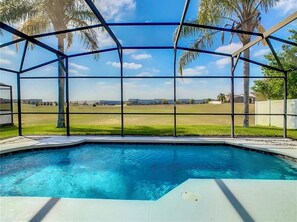 A swimming pool with a clear view of the surrounding landscape, enclosed by a metal fence. - Minutes from the Magic .Private Pool • Harry Potter Game Room • Sleeps 10 (Davenport)