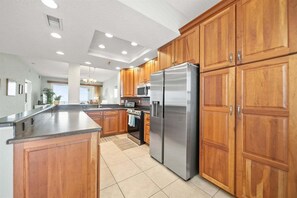 The kitchen features stainless steel appliances and plenty of storage for all your cooking needs. - Oceanfront, Resort Pools & Private Beach Access | Surf Club 1502 (Palm Coast)