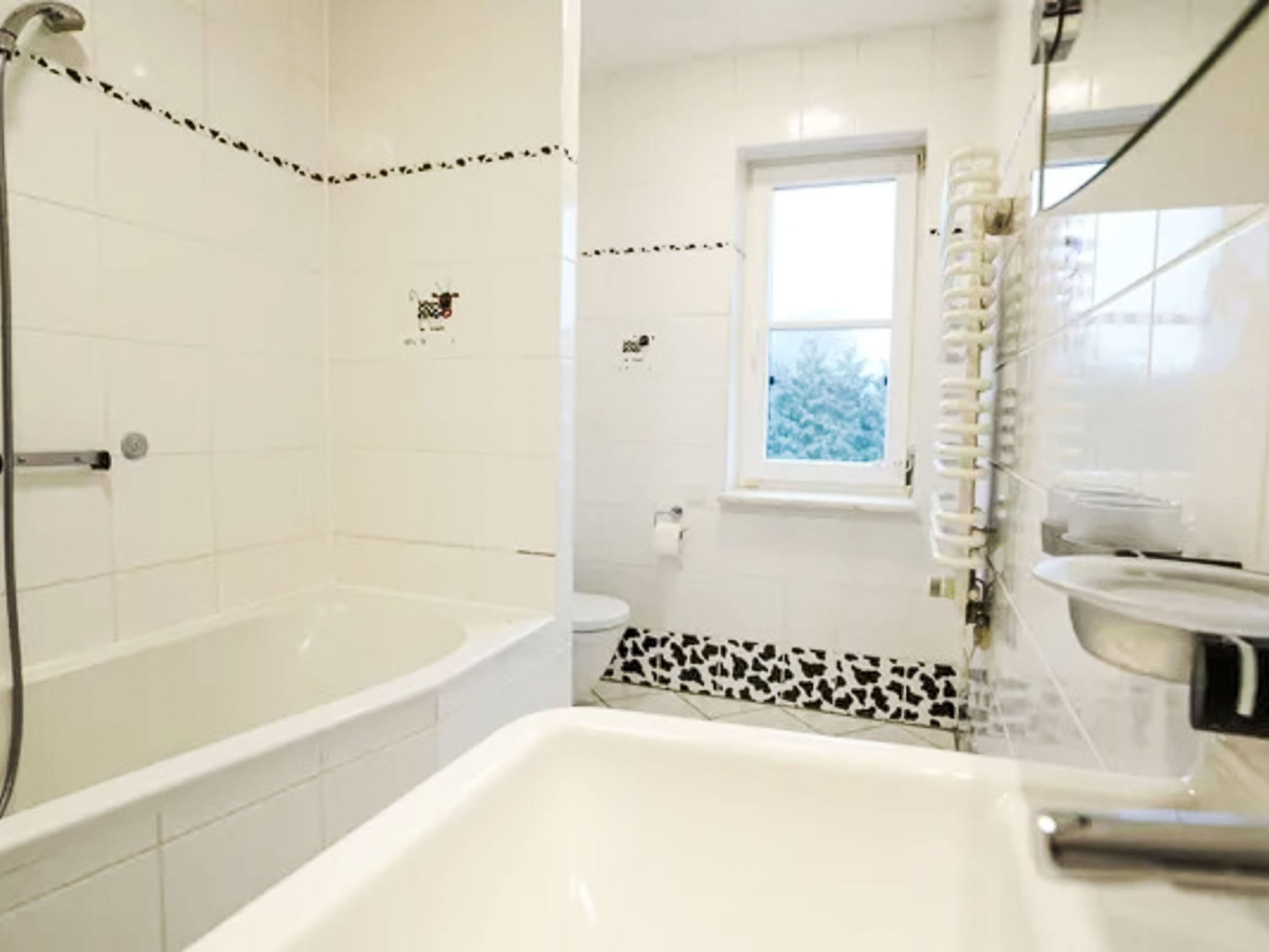 A bathroom with a bathtub, a shower, and a toilet.