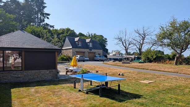 A residential area with a house, a tennis court, and a parked boat. - Ty Venoux - ELVEN - Vacation Rental (ELVEN)