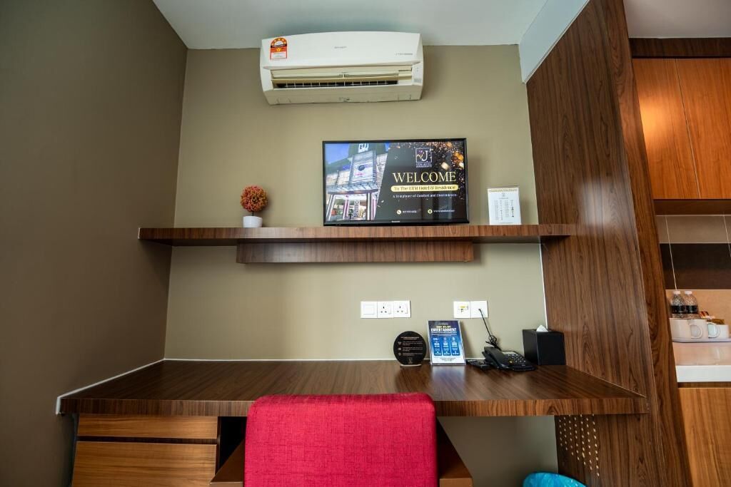 A reception desk with a welcome sign, an air conditioner, and a telephone.