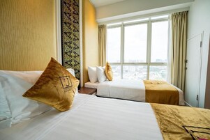 A hotel room with two beds, a large window with a view, and a patterned wall.