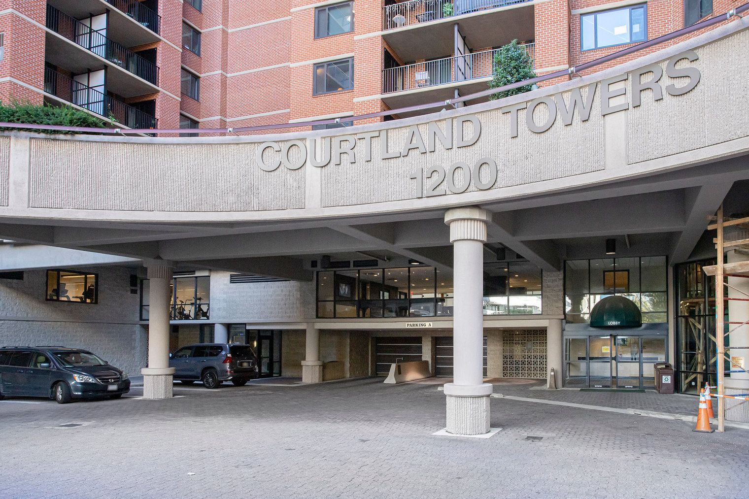 A multi-story building with a sign reading 'COURTLAND TOWERS 1200'.