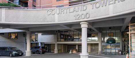 A multi-story building with a sign reading 'COURTLAND TOWERS 1200'.