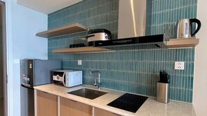 A modern kitchen with a built-in stove, microwave, and sink.