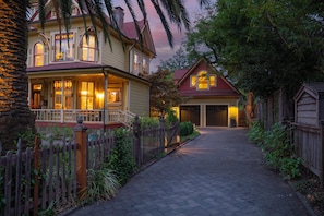 A two-story house with a porch and a garage.