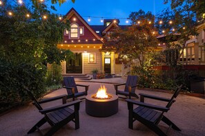 A house with a fire pit and outdoor seating.