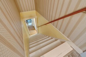 A staircase with a handrail leading to an upper floor.