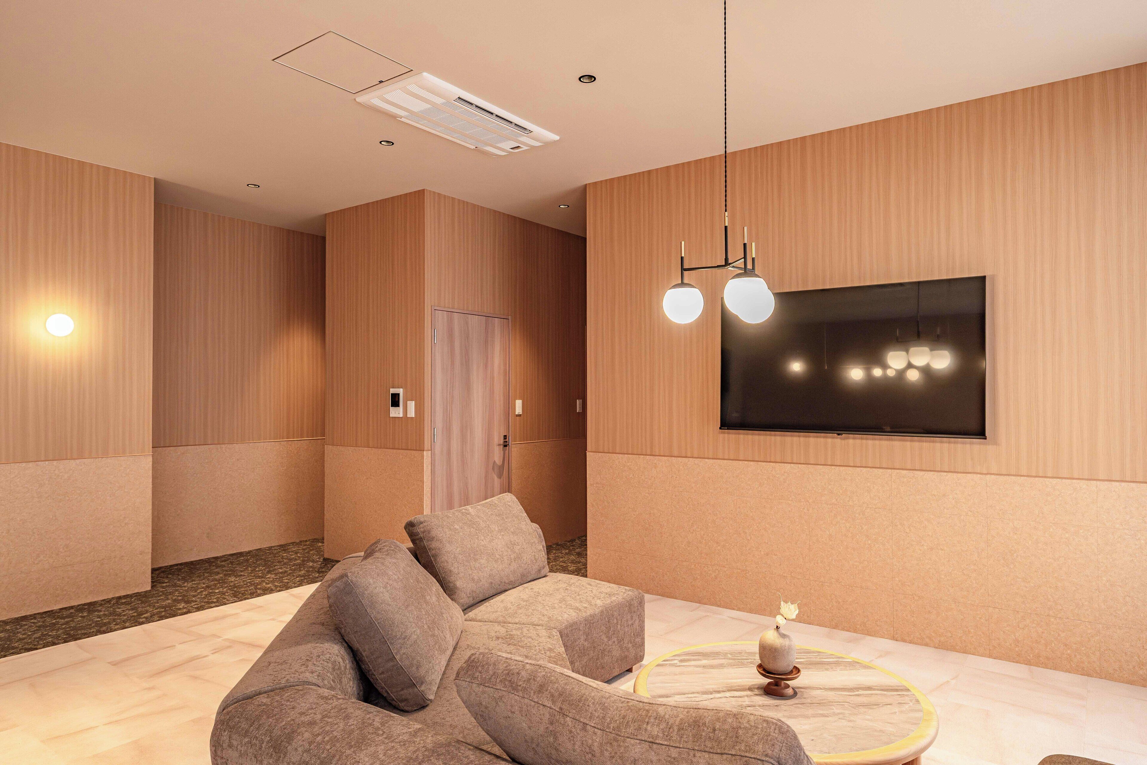 Deluxe Suite | Living area | 40-inch flat-screen TV with digital channels