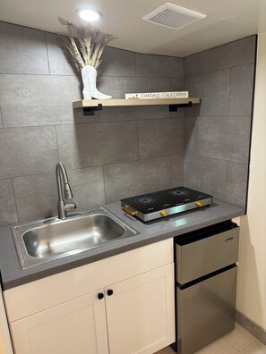 A modern kitchen with a stainless steel sink, a built-in stove, and a white cabinet. - Welcome to Oakdale, Ca Comfortable Private Bedroom/Bath,
69 miles to Yosemite. (Oakdale)