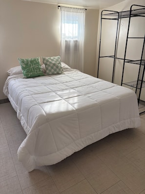 A neatly made bed with a white duvet, two pillows, and a window with sheer curtains. - Welcome to Oakdale, Ca Comfortable Private Bedroom/Bath,
69 miles to Yosemite. (Oakdale)