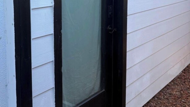 A black-framed door with a frosted glass panel, a doormat with 'welcome' text, and a wall-mounted light fixture. - Welcome to Oakdale, Ca Comfortable Private Bedroom/Bath,
69 miles to Yosemite. (Oakdale)