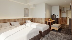 A hotel room with two beds, a small table with a fruit bowl, and a kitchenette area. - Apartment Hotel 11 Kuromon 9 (Osaka-shi)