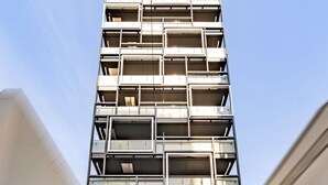 A multi-story building with a modern architectural design, featuring a series of balconies and a prominent entrance labeled 'APARTMENT HOTEL II'. - Apartment Hotel 11 Dotonbori 9 (Osaka-shi)