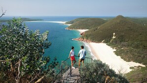 A coastal landscape with a beach and hills. - Bella Vista Shoal Bay (Shoal Bay)