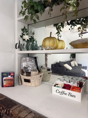 A coffee bar setup with a book titled 'The Home Bartender' and a 'Coffee Bar' sign. - 3-bedroom House w/private pool - Family & Pet Friendly (Sacramento)