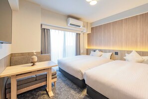 A hotel room with two beds, a desk, and a seating area. - Apartment Hotel 11 Dotonbori 10 (Osaka)
