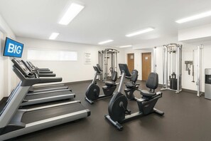 A fitness center with treadmills, elliptical machines, and weightlifting equipment. - Waikiki 2BR 2BA 34th Fl Ocean View Sunset/Sunrise (Honolulu)