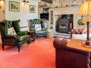 A cozy living room with leather armchairs, a fireplace, and a television. - 1 bedroom accommodation in Clitheroe and the Ribble Valley (Clitheroe and the Ribble Valley)