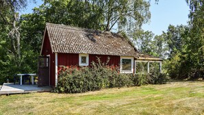 A red wooden house with a tiled roof, a small porch, and a window. - 1 bedroom beautiful home in Mörrum (Mörrum)