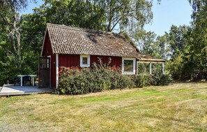 A red wooden house with a tiled roof, a small porch, and a window. - 1 bedroom beautiful home in Mörrum (Mörrum)