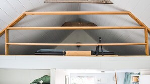 A loft-style room with a sloped ceiling and a wooden beam structure. - 1 bedroom beautiful home in Mörrum (Mörrum)
