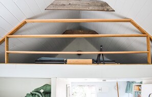 A loft-style room with a sloped ceiling and a wooden beam structure. - 1 bedroom beautiful home in Mörrum (Mörrum)