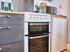 A kitchen with a built-in oven, a microwave, and a toaster. - No.1 West Beach Apartments - UK52002 (Portrush)