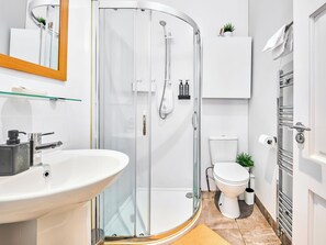 A modern bathroom with a glass-enclosed shower, a white sink, and a toilet. - No.3 West Beach Apartments - UK52003 (Portrush)