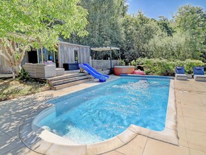 A swimming pool with a slide, a hot tub, and outdoor seating. - 5 bedroom accommodation in Redford (Redford)