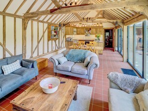 A cozy living room with a sofa, a coffee table, and a fireplace. - 2 bedroom accommodation in Steyning (Steyning)