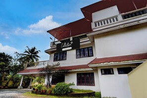 A two-story building with a sign that reads 'Collection Company-Serviced.' - Collection O Kangarappady Formerly (Kanayannur)