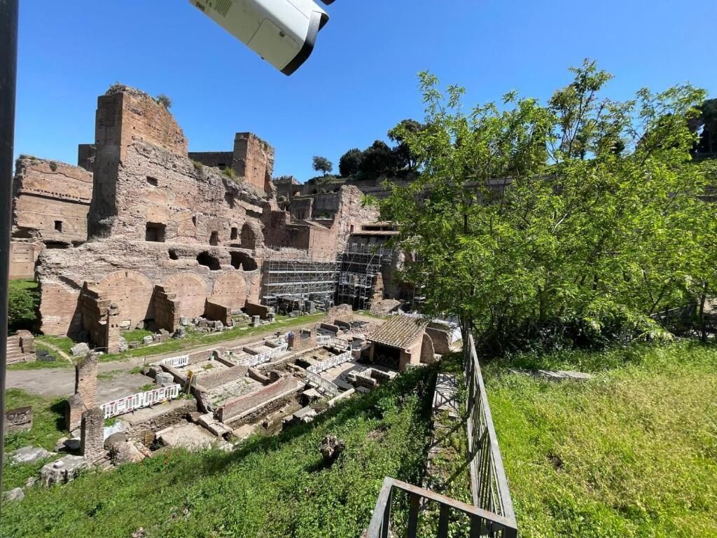 Ancient ruins with stone structures and a grassy area.