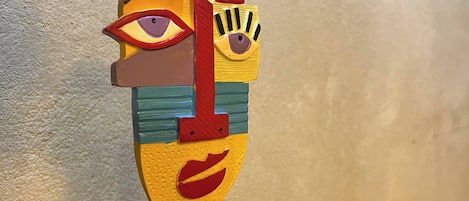 A colorful abstract sculpture on a black pedestal.