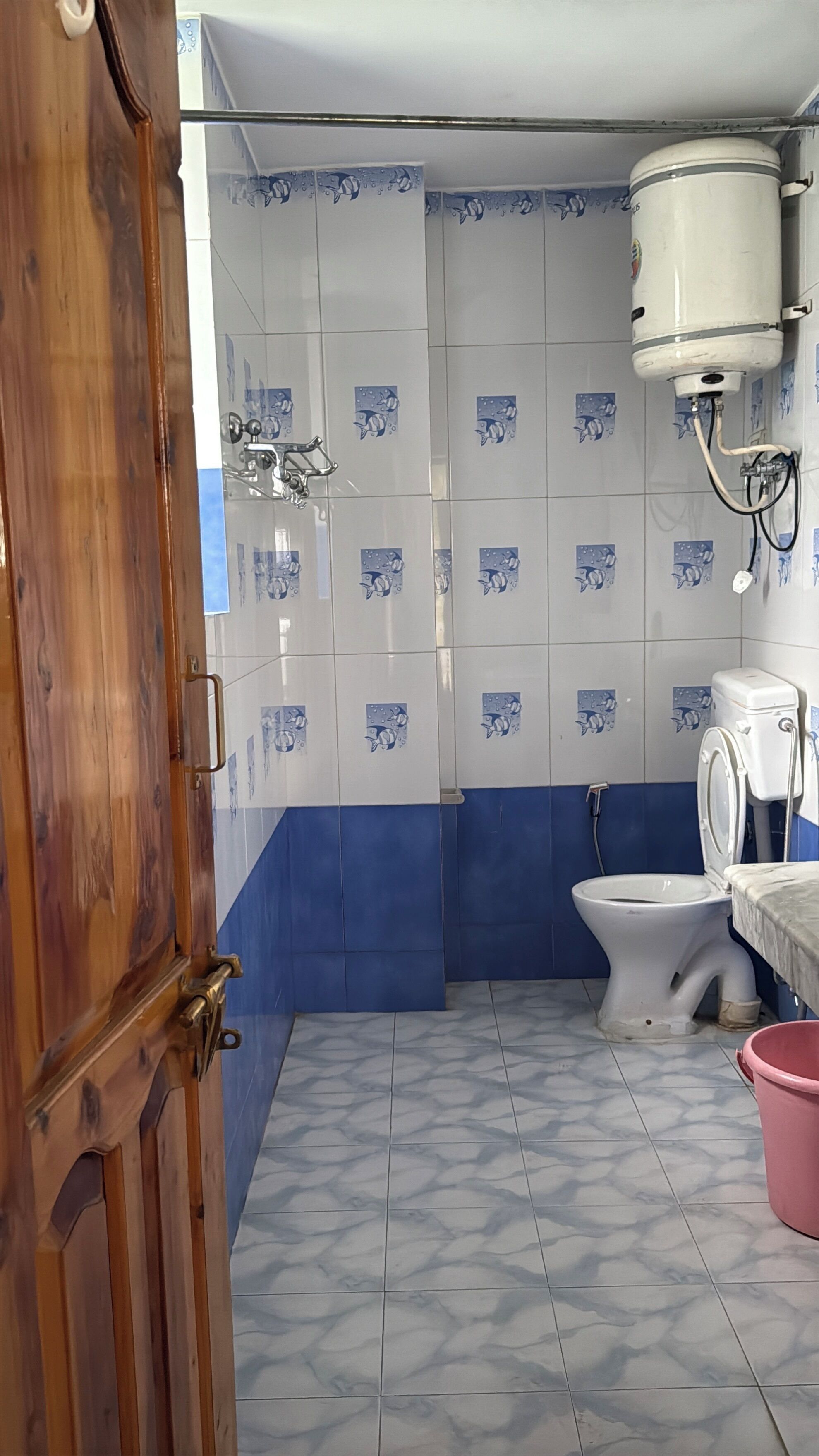 A bathroom with a toilet, bidet, and a shower area.