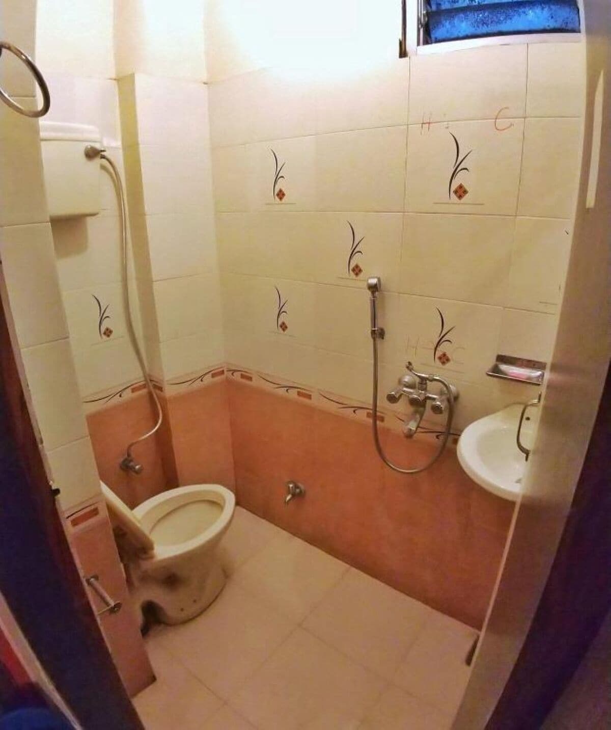 A bathroom with a toilet, a sink, and a shower.