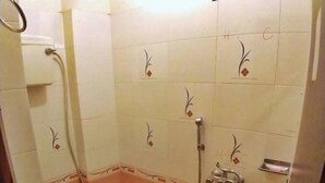 Un baño con inodoro, lavamanos y ducha.