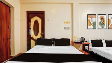 A hotel room with two beds, a wooden door, a wall-mounted light switch, and a 'Prohibited Area' sign.