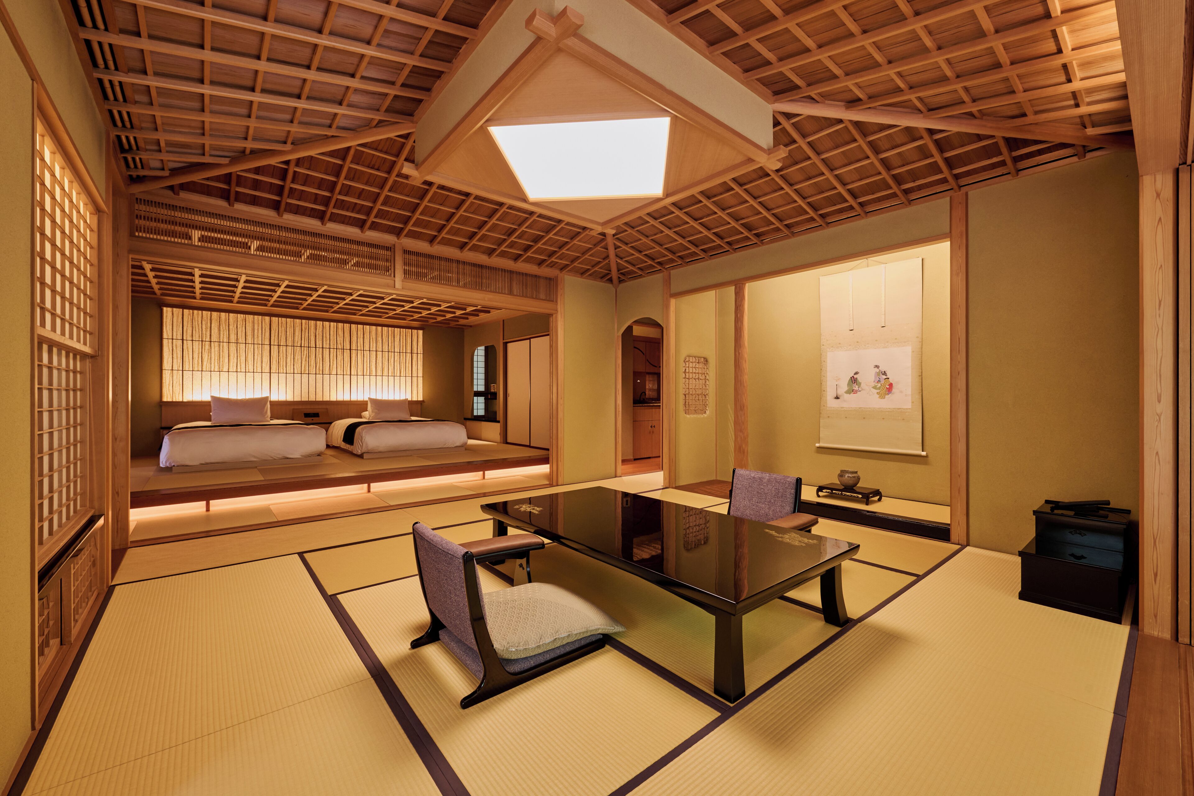 A traditional Japanese room with tatami flooring, a low table, and a sofa with cushions.