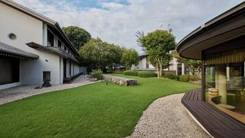 A modern building with a well-maintained lawn and a gravel pathway leading to the entrance.