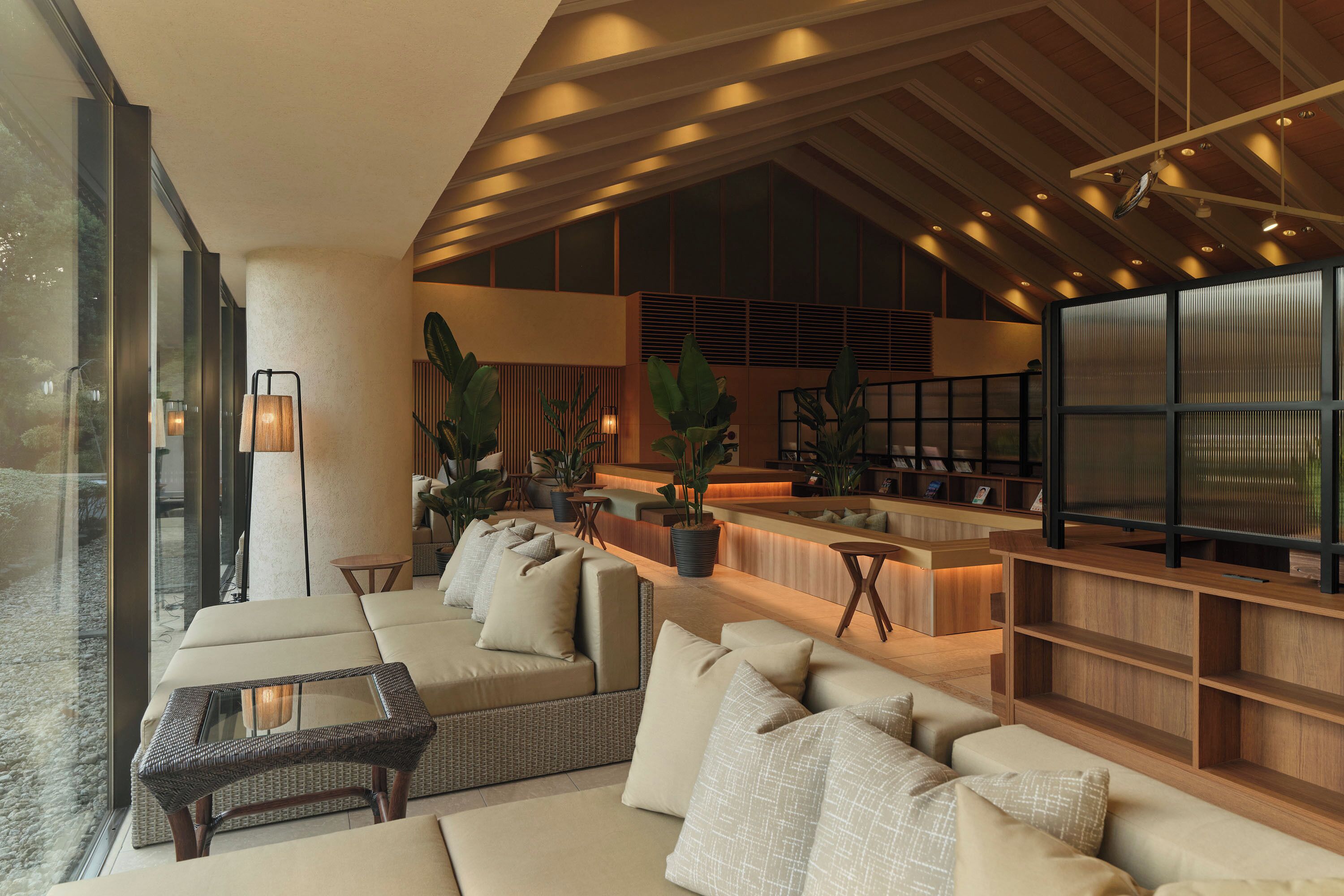 A modern lounge area with a sofa, a coffee table, and a bar area with seating.