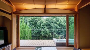 A modern interior with a large sliding glass door leading to a wooden deck.