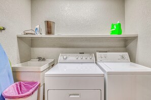 A laundry room with two washing machines, a sink, and a shelf with cleaning supplies. - Hike & Ski! Quiet Home w/ Solarium in Cloudcroft (Cloudcroft)