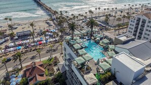 A coastal hotel with a pool, beach access, and a pier. - Steps to the Sand! Luxury Oceanside Pier Condo (Oceanside)